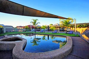 In-ground swimming pool, BBQ and children’s play area at Bell Tower Motor Inn In-ground swimming pool, BBQ and children’s play area at Bell Tower Motor Inn